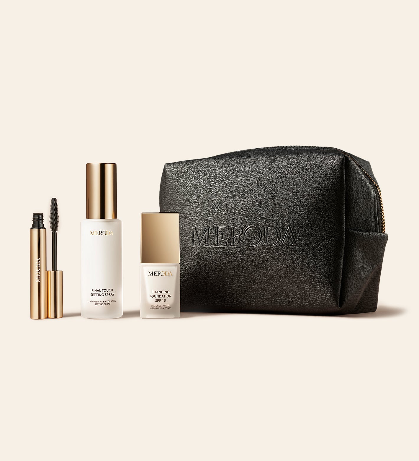 Travel Kit met Mini Gilded Lashes Mascara, Mini Final Touch Setting Spray, Mini Changing Foundation en een zwarte reistas.